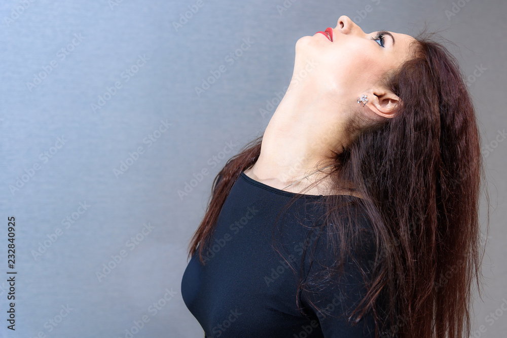 Fototapeta premium Studio portrait concept of a smiling beautiful brunette girl talking on a white background.