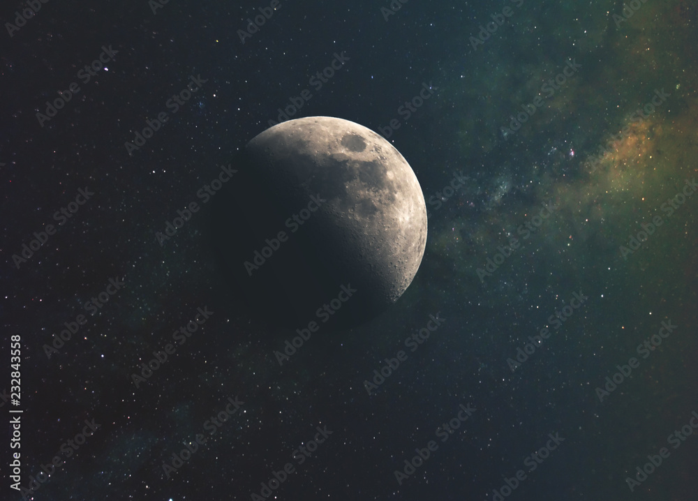 the moon against the milky way and the rays of the sun in the infinite space of the universe