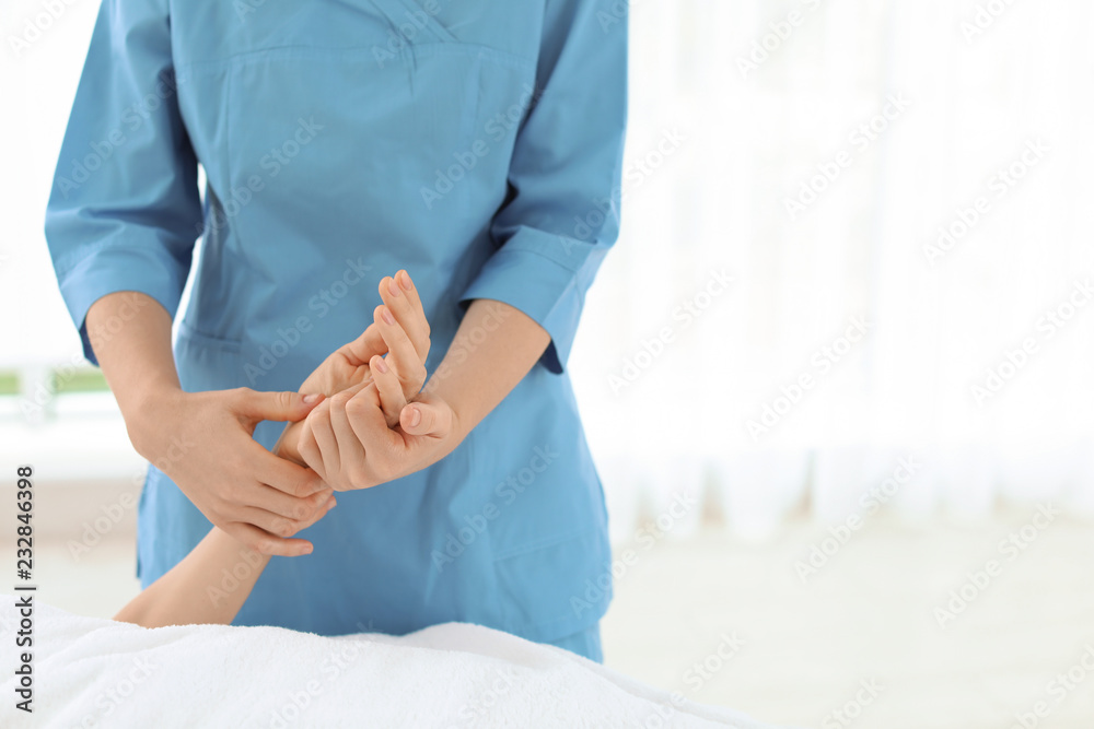 Woman receiving hand massage in wellness center