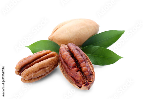 Pecan nuts and leaves on white background