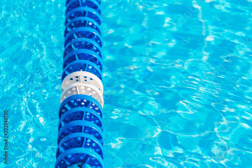 Swimming pool water with blue lane marker © taniasv