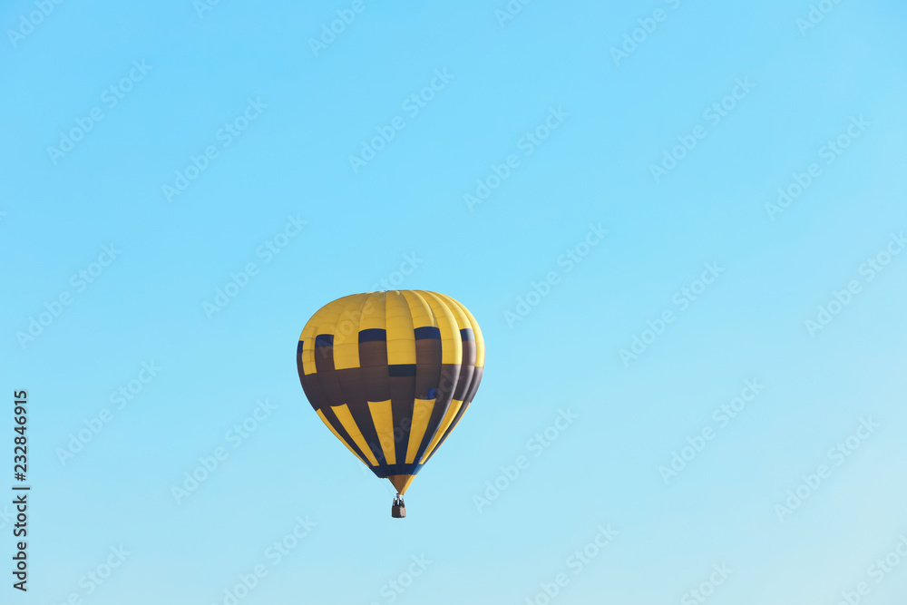 Colorful hot air balloon flying in blue sky. Space for text Colorful hot air balloon flying in blue sky. Space for text