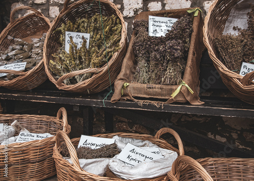 wicker baskets with dried herbs, spices for sale