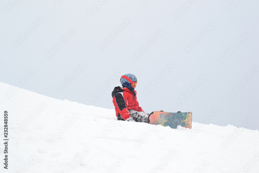 A small child fell off a snowboard