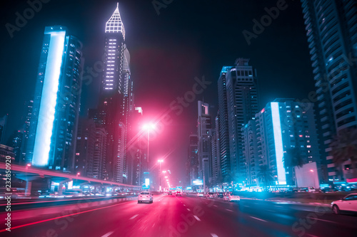 Driving a car on Sheikh Zayed Rd in Dubai at night, United Arab Emirates. Blu...
