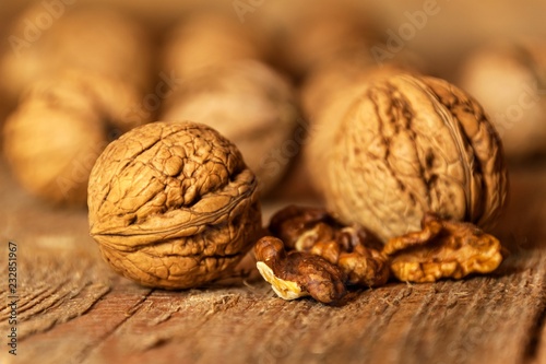 Walnuts on an old wooden table. Healthy Nuts. Blurred background. Vegetarian food.