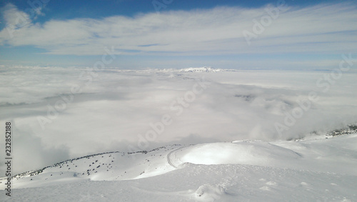 Snowy mountains over the clouds
