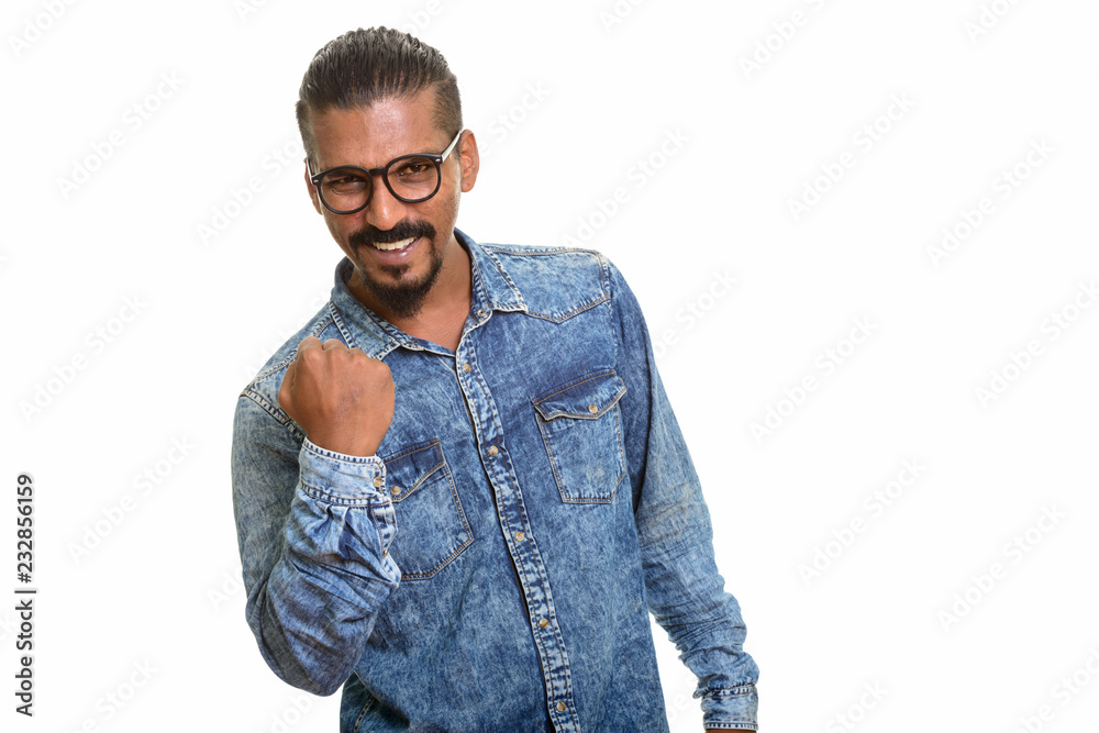 Young happy Indian man looking motivated studio portrait against white background Young happy Indian man looking motivated studio portrait against white background