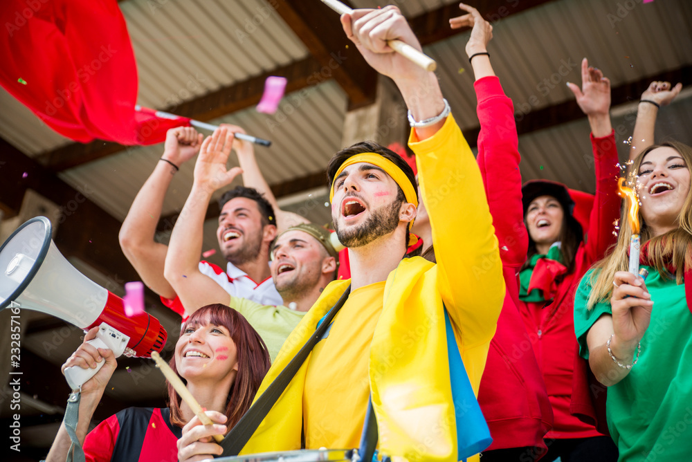 Fototapeta premium Football supporters at the stadium - Football fans having fun and looking at football match