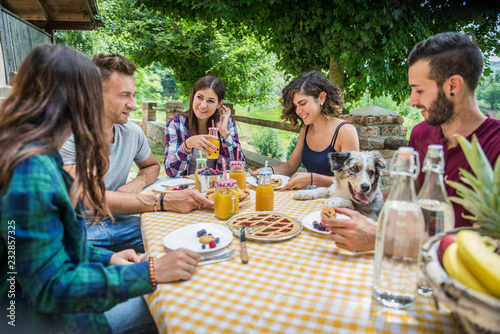 Group of friends having breakfast in a farmhouse