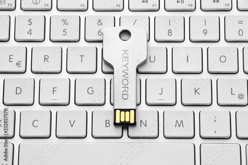 Silver USB stick ona white  keyboard - caption keyword photo