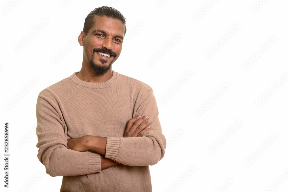 Young happy Indian man smiling with arms crossed Young happy Indian man smiling with arms crossed