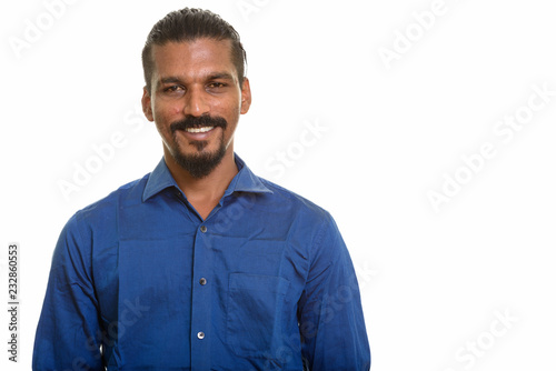 Young happy Indian businessman smiling studio portrait against white background © Ranta Images
