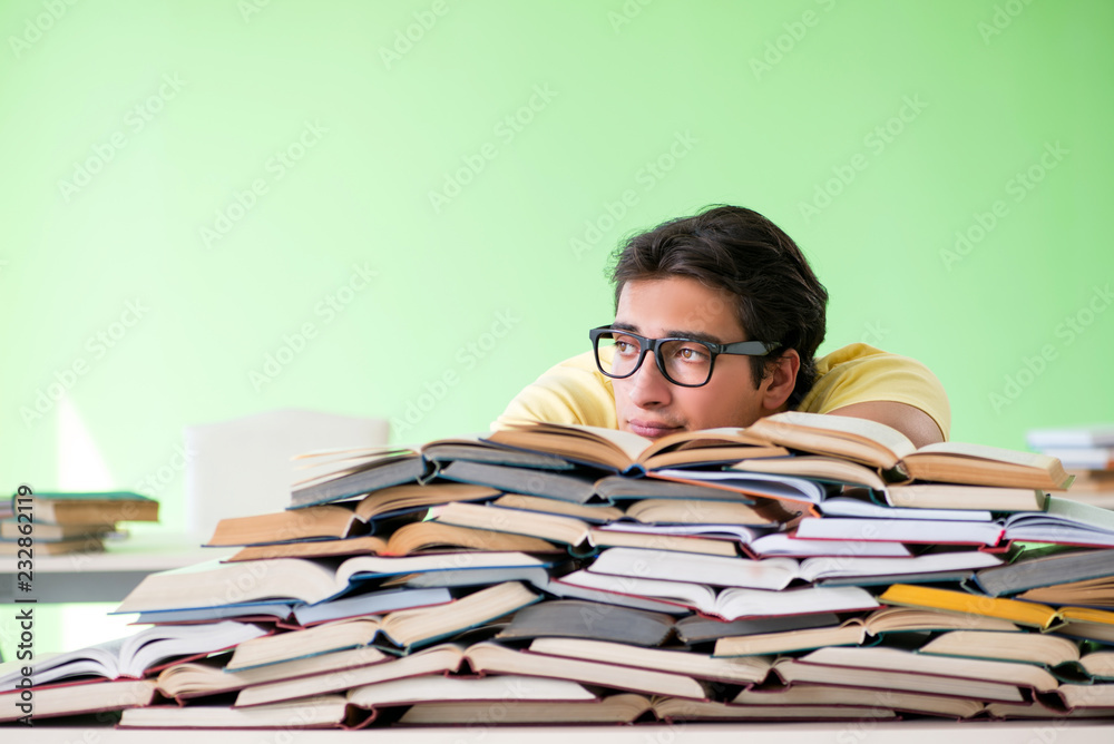 Student with too many books to read before exam Student with too many books to read before exam