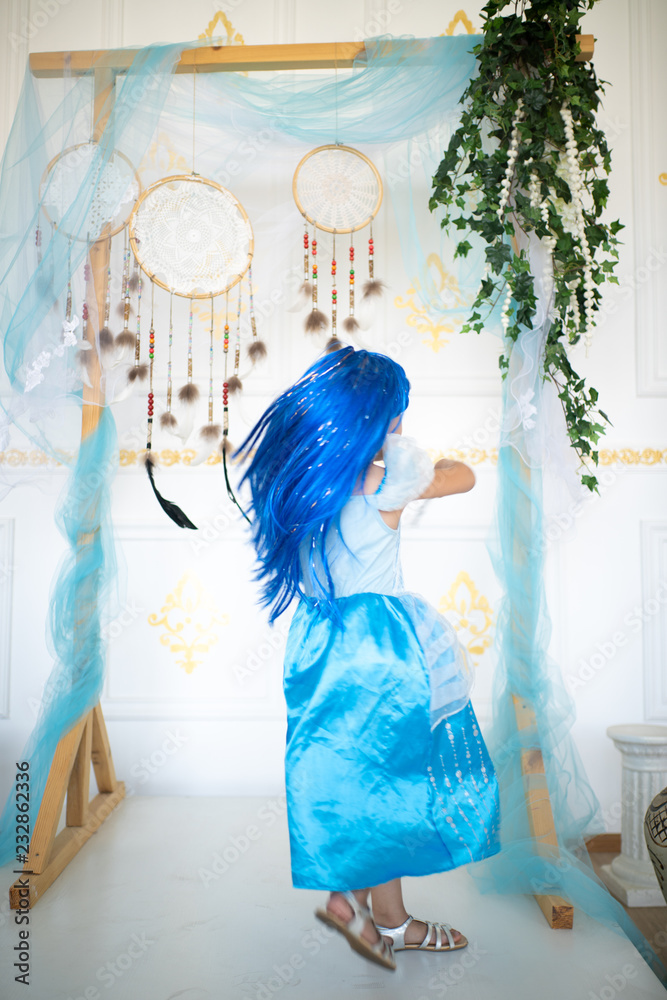 Fototapeta premium little girl in a blue wig