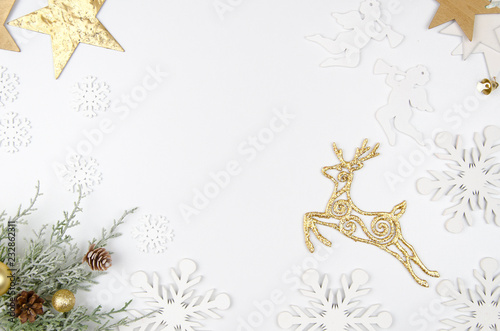 Christmas mockup flat lay styled scene with christmas decorations, angels, golden deer, stars and snowflakes . Copy space White wooden background photo
