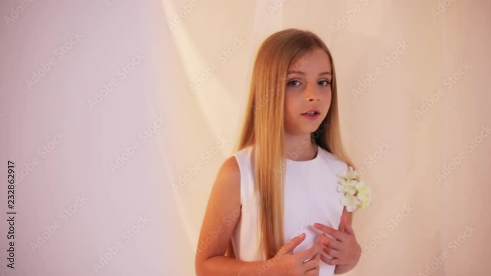 Cute little girl with long hair white dress singing a song stand white background childhood joy kid happiness enjoy having happy portrait smile beautiful close up slow motion Cute little girl with long hair white dress singing a song stand white background childhood joy kid happiness enjoy having happy portrait smile beautiful close up slow motion