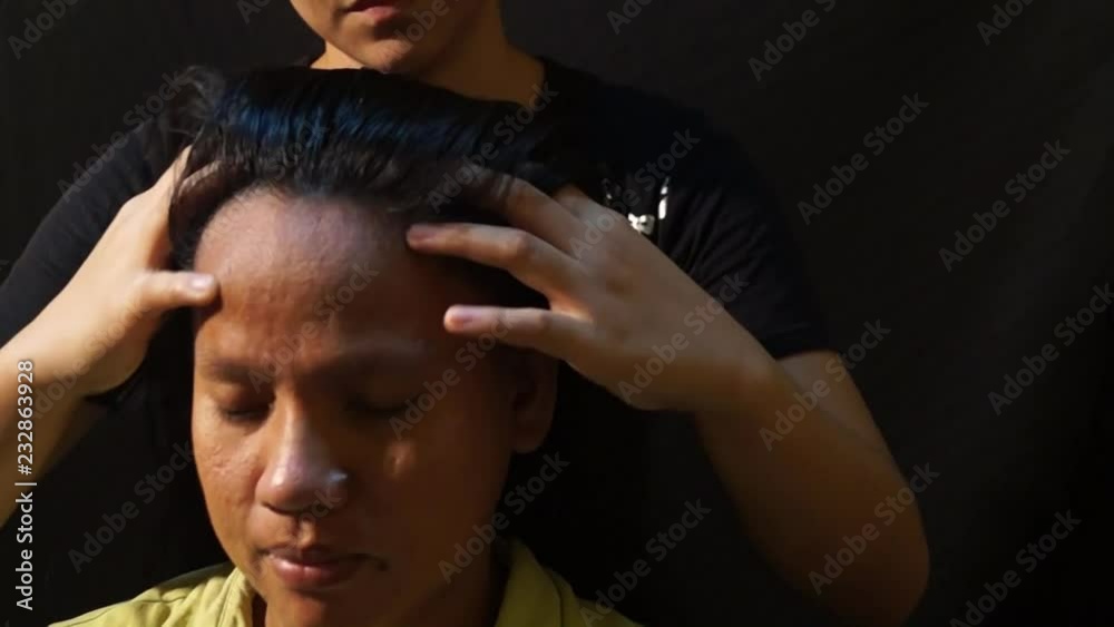 Lady masseuse shows how to massage head, face and hair Illustrative Editorial Lady masseuse shows how to massage head, face and hair Illustrative Editorial
