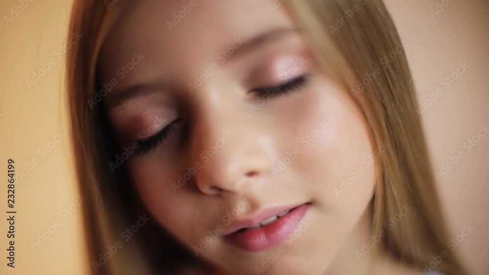 Pretty face cute little girl with long hair opens his eyes look at the camera happy charming child baby kid smile fun enjoy mouth portrait young communication dialogue cute close up slow motion Pretty face cute little girl with long hair opens his eyes look at the camera happy charming child baby kid smile fun enjoy mouth portrait young communication dialogue cute close up slow motion