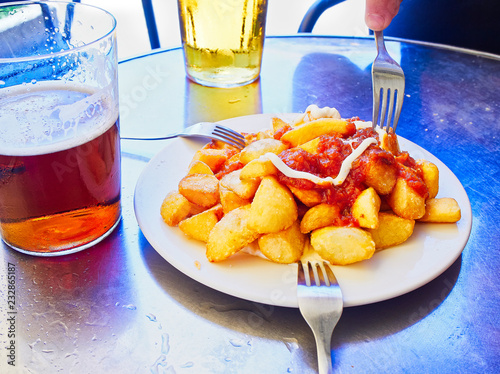 Patatas Bravas, fried potatoes with spicy sauce, one of the most common typical Spanish tapas.. photo