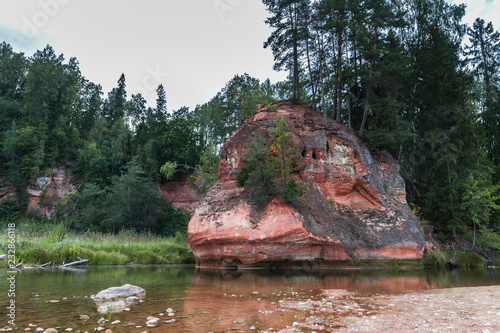 Summer landscape and red stone cliff of Amata river, Latvia, Europe. photo