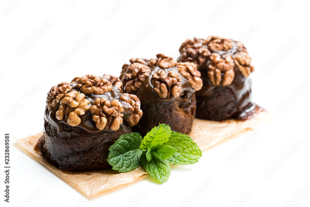Sticky chocolate and walnut puddings isolated on white