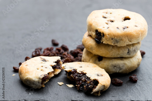 Stack of Eccles cakes on black stone background photo