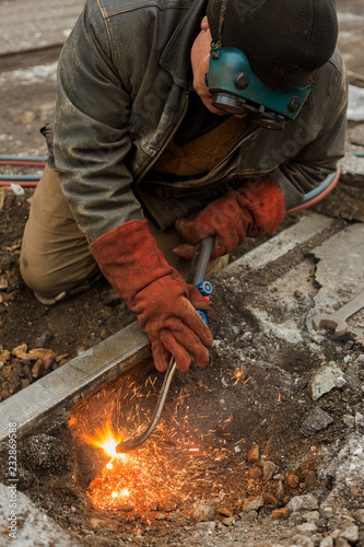 Repair of iron tram line. Installation of railway rails for trams. Laying stone pavers, road paving slabs on street. Repair and reconstruction of urban highways with tram line