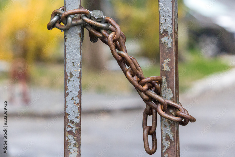 Rusty chain at the gate. Secret object. Guarded territory. Iron shackles. Zarkyta parking. Rusty chain at the gate. Secret object. Guarded territory. Iron shackles. Zarkyta parking.