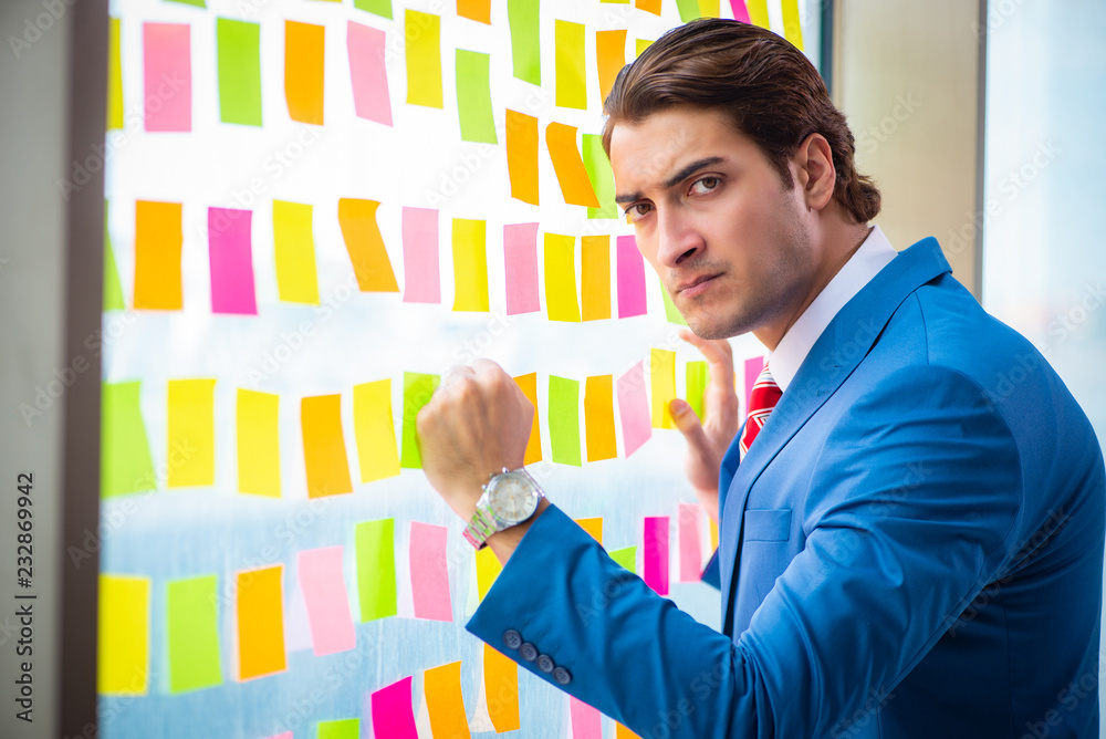 Young handsome employee with many conflicting priorities Young handsome employee with many conflicting priorities