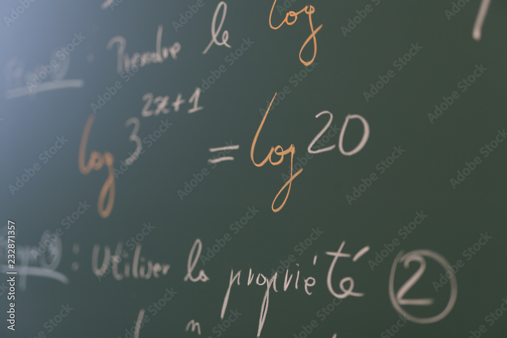 Mathematical formulae on a blackboard in a classroom.