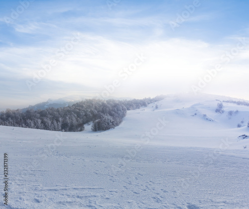 snowbound winter plain with hills at the evening © Yuriy Kulik