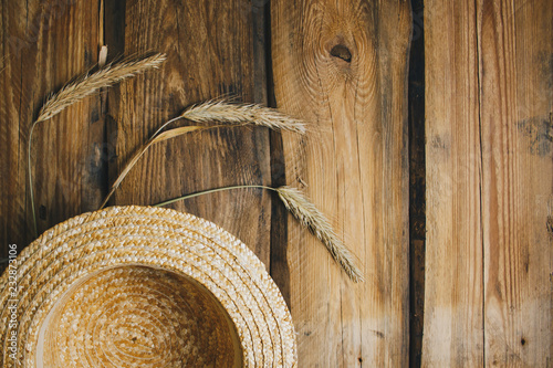 Farmhouse vintage table with straw hat and spikelets of wheat. Autumn, summer top view with copy space. Flat lay for lettering, text, blogs, magazines, headers, freelanse closeup photo