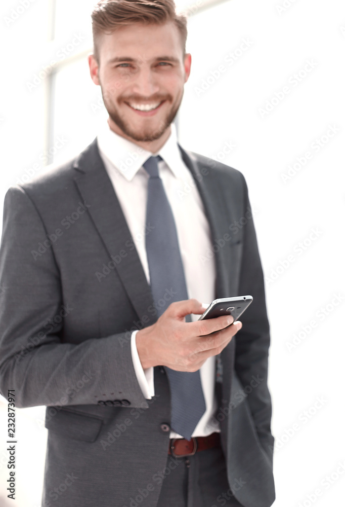 close up.successful businessman on the background of the office window. close up.successful businessman on the background of the office window.