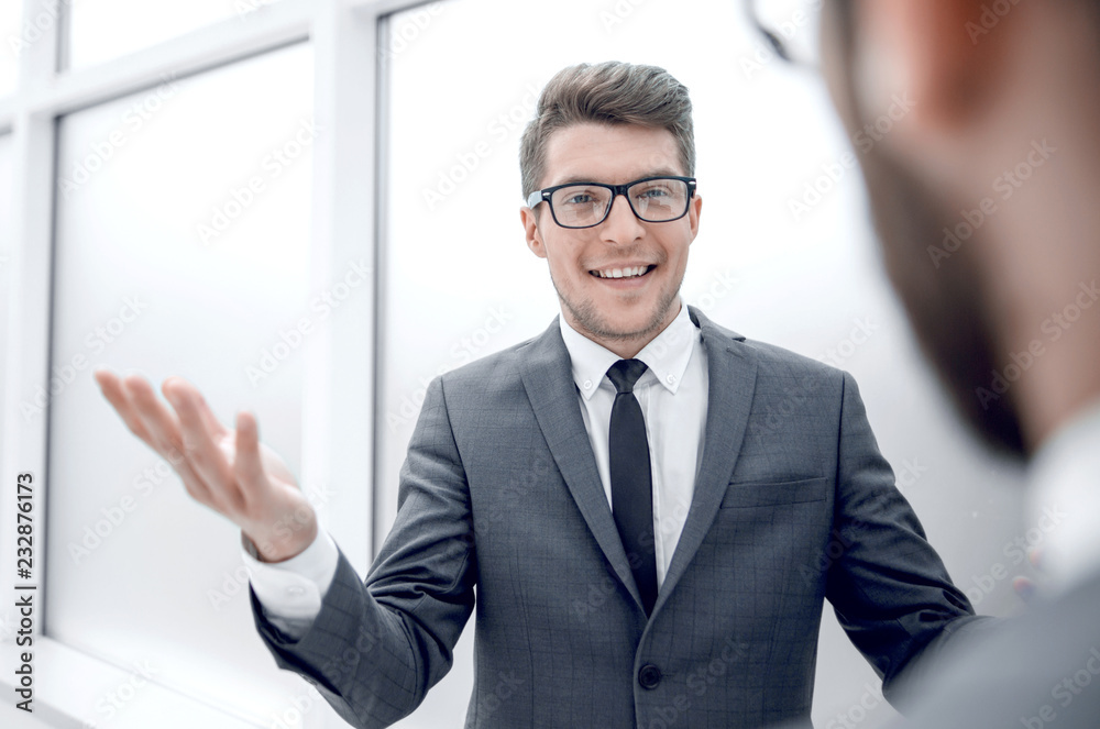 young businessman talking standing in the office young businessman talking standing in the office