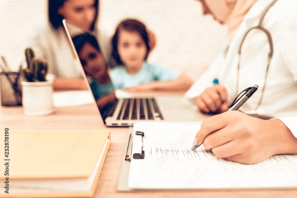 Mother with Son at Arabic Doctor's Appointment