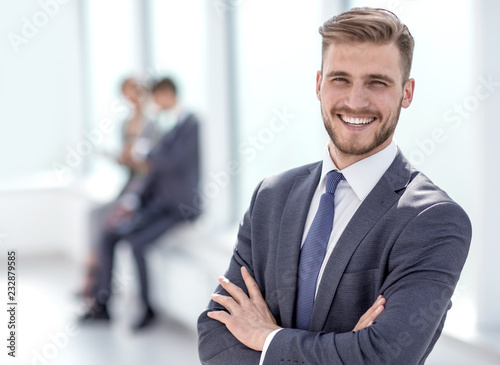 successful businessman on the background of a bright office. photo