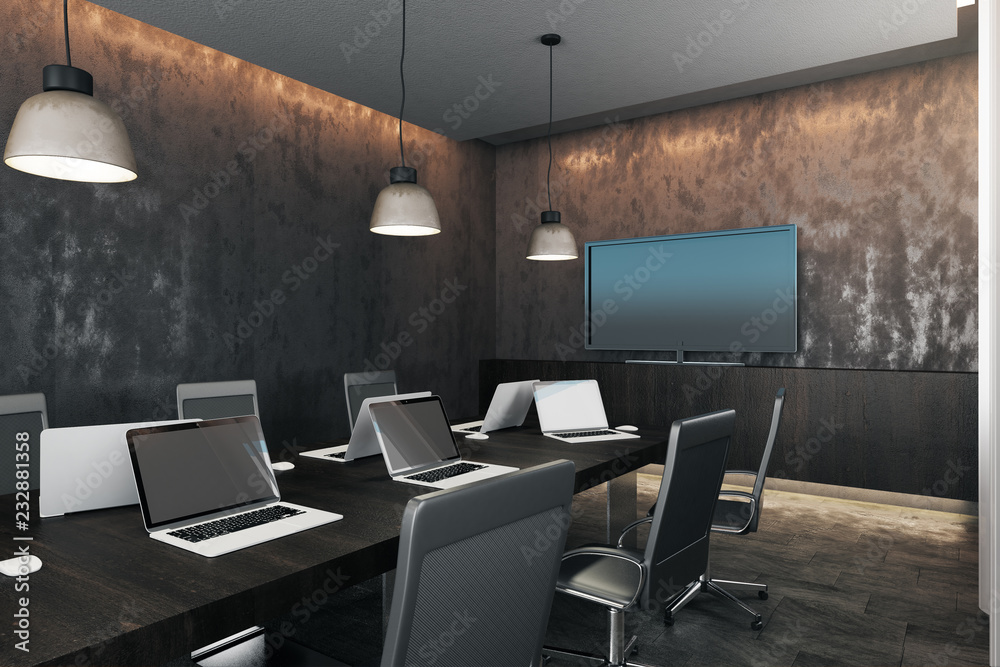 Dark meeting room with device screens Dark meeting room with device screens
