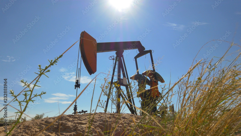 Naklejka premium Industrial jack pump platform working on oil field in Texas