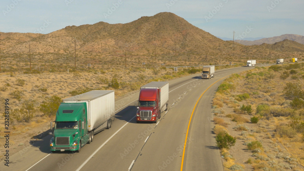 Cars and trucks driving on busy highway, freight semi trucks transporting goods