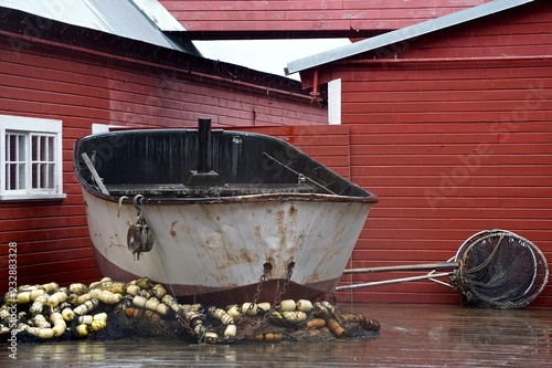 Hoonah, Alaska, USA: A rusty fishing boat and various fishing nets on display at the Icy Strait Point Visitors Center in Hoonah, Alaska. photo