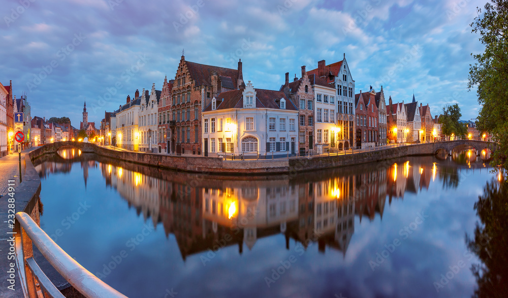 Scenic cityscape with a medieval fairytale Old town, the Spiegelrei and the Langerei canals at night in Bruges, Belgium