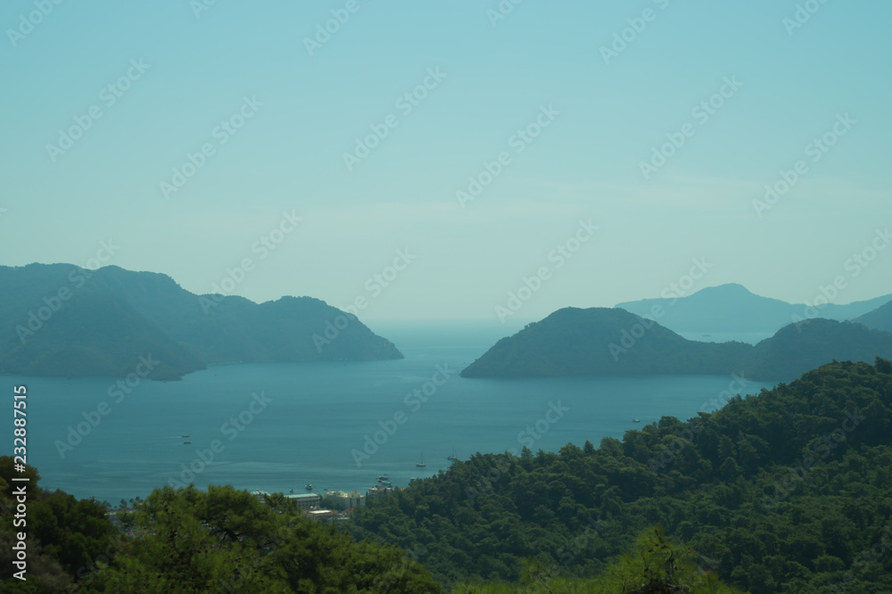 Landscape with the mountains and islands. Seascape background. water surface in a bay