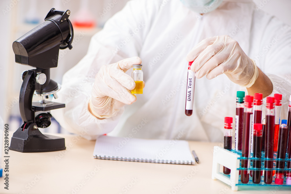 Young handsome lab assistant testing blood samples in hospital Young handsome lab assistant testing blood samples in hospital