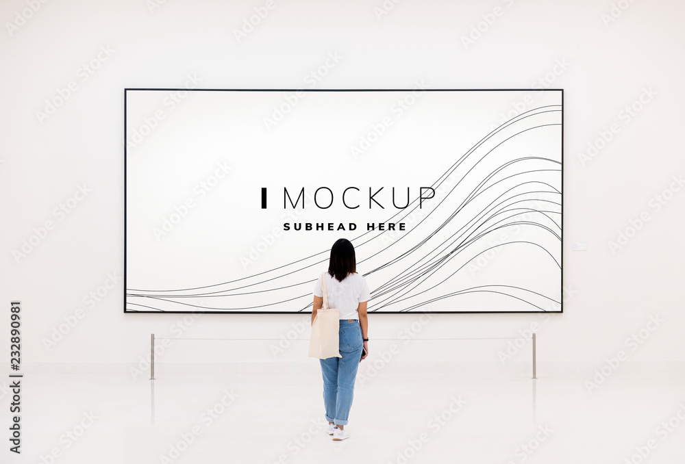 Woman at an exhibition looking at an art piece mockup Woman at an exhibition looking at an art piece mockup