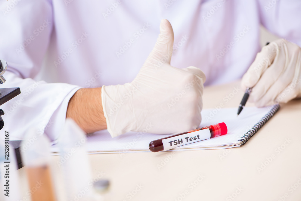 Young handsome lab assistant testing blood samples in hospital Young handsome lab assistant testing blood samples in hospital