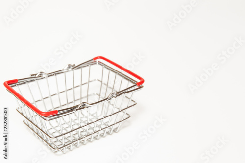 Stainless shopping basket close up on white background.