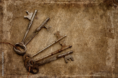 A ring of vintage skeleton keys with a textured background