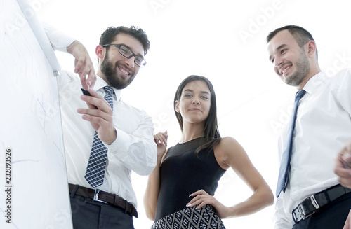 Fototapeta Naklejka Na Ścianę i Meble -  business team looking at a blank flipchart.