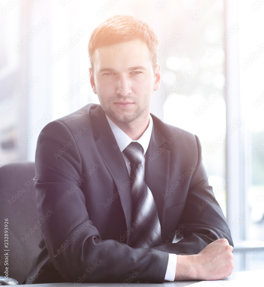 Fototapeta premium portrait of confident businessman sitting behind a Desk